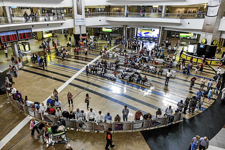 South Africa, Johannesburg, O. R. Tambo International Airport, terminal concourse area passengers overhead view. (Photo by: Jeffrey Greenberg/UIG via Getty Images)